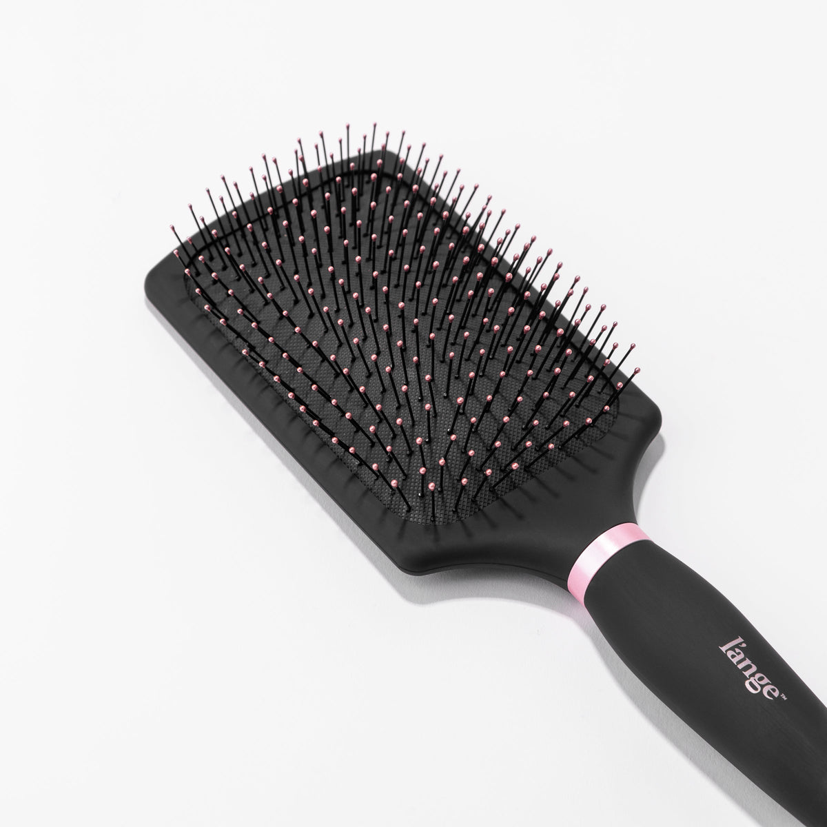 You can clearly see the rounded, pink-tipped bristles on the black nylon bristle brush.