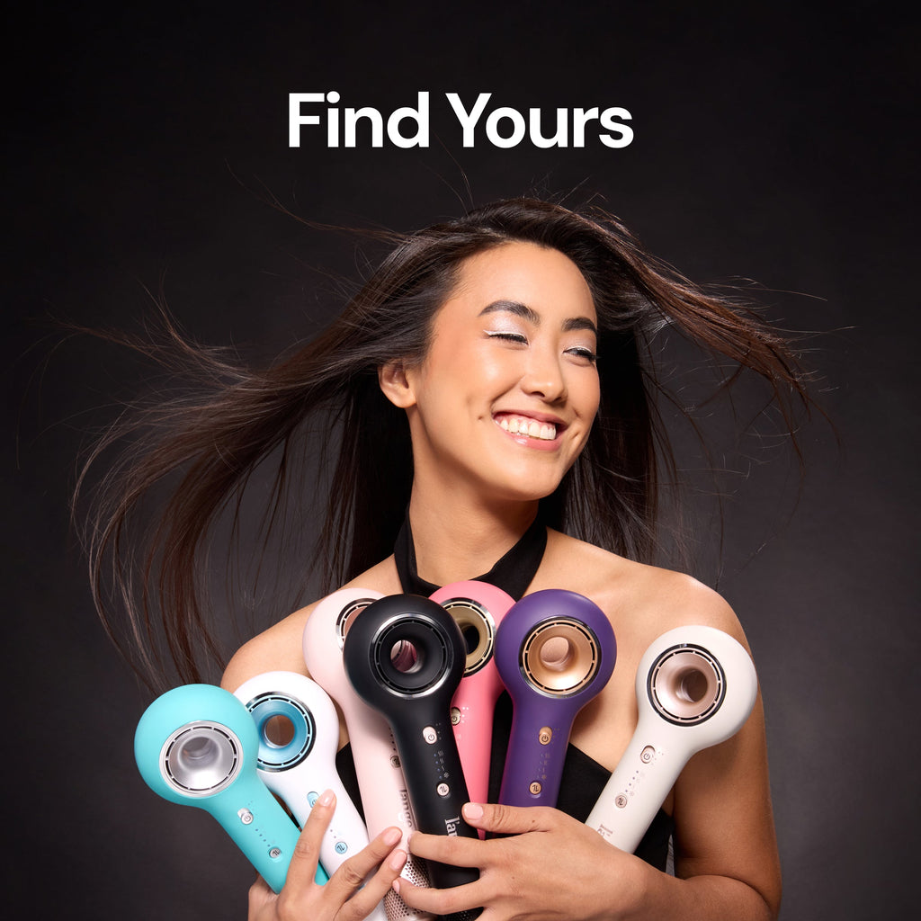 Smiling woman with windblown hair holding six L'ange hair dryers in different colors (teal, white, pink, black, purple, cream), with text "Find Yours."