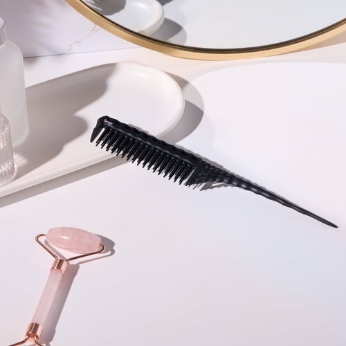 Black pin-tail teasing comb on a vanity tray 