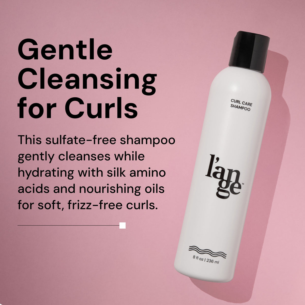 A bottle of L’ange Curl Care Shampoo is displayed against a pink background, angled with a shadow. On the left, bold text reads: 'Gentle Cleansing for Curls.' Below, supporting text says: 'This sulfate-free shampoo gently cleanses while hydrating with silk amino acids and nourishing oils for soft, frizz-free curls.' The white bottle features the l’ange logo and product information, indicating it contains 8 fl oz (236 ml)