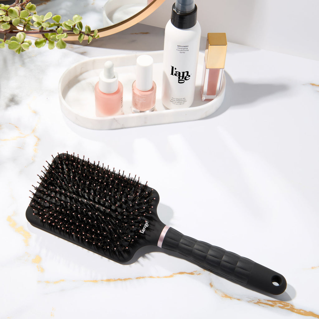 L’ange detangling paddle brush with boar  on a vanity 
