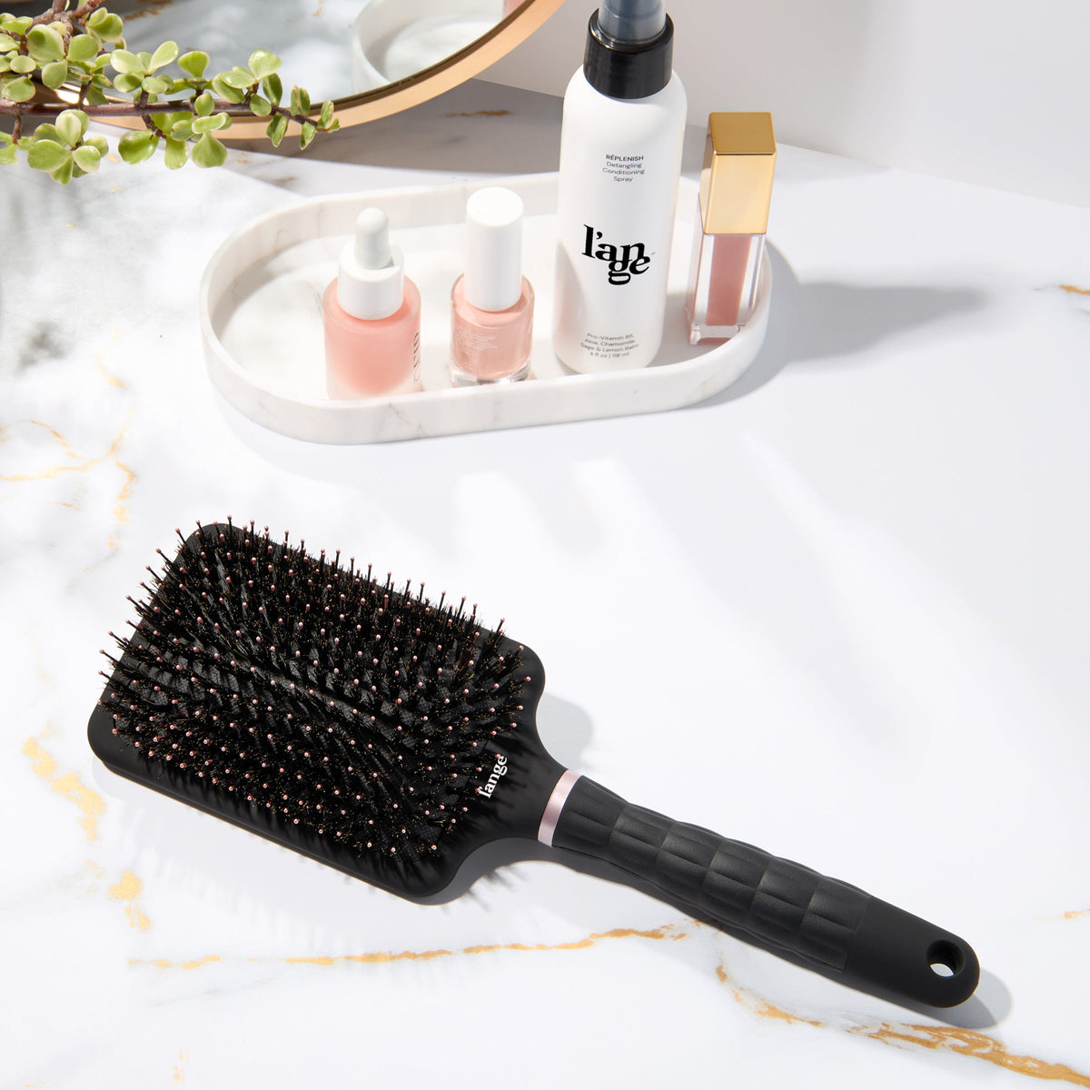 L’ange detangling paddle brush with boar  on a vanity 