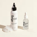 Happy Roots Scalp Calm Serum and Happy Roots Post-Cleanse Clarifying Wash bundle, on beige background