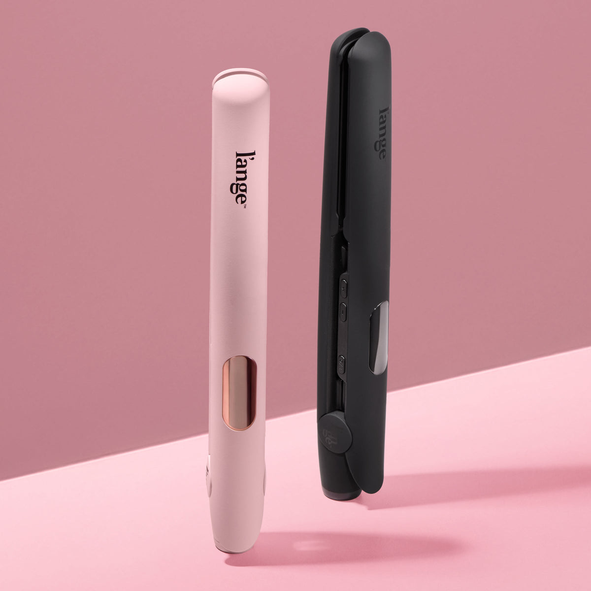 Two L’ange Le Ceramique Luxe in blush and black displayed upright on a blush background.