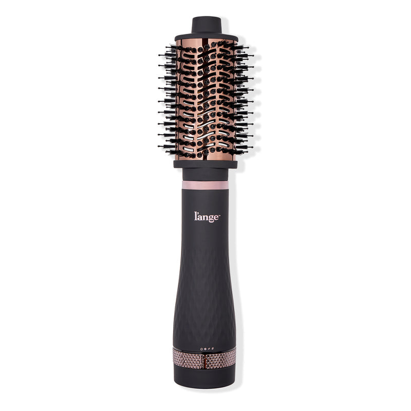 A black and rose gold round hairbrush with a built-in dryer function, featuring a sleek ergonomic handle.