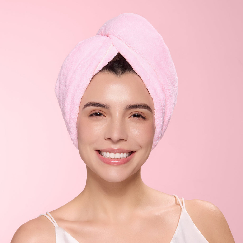 Woman with blush hair wrap towel around her head