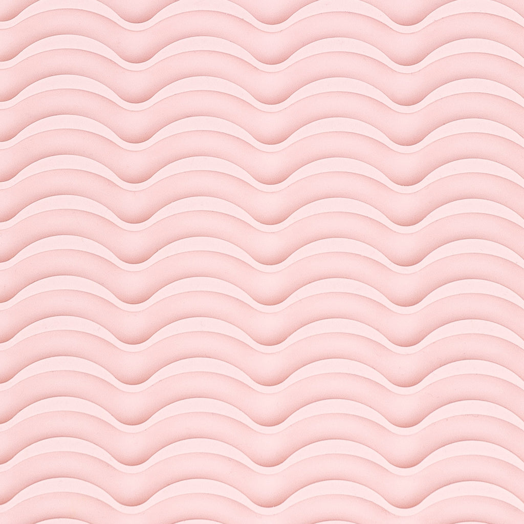 It shows a close-up of the silicone rippled surface of the styling tool heat-resistant mat.
