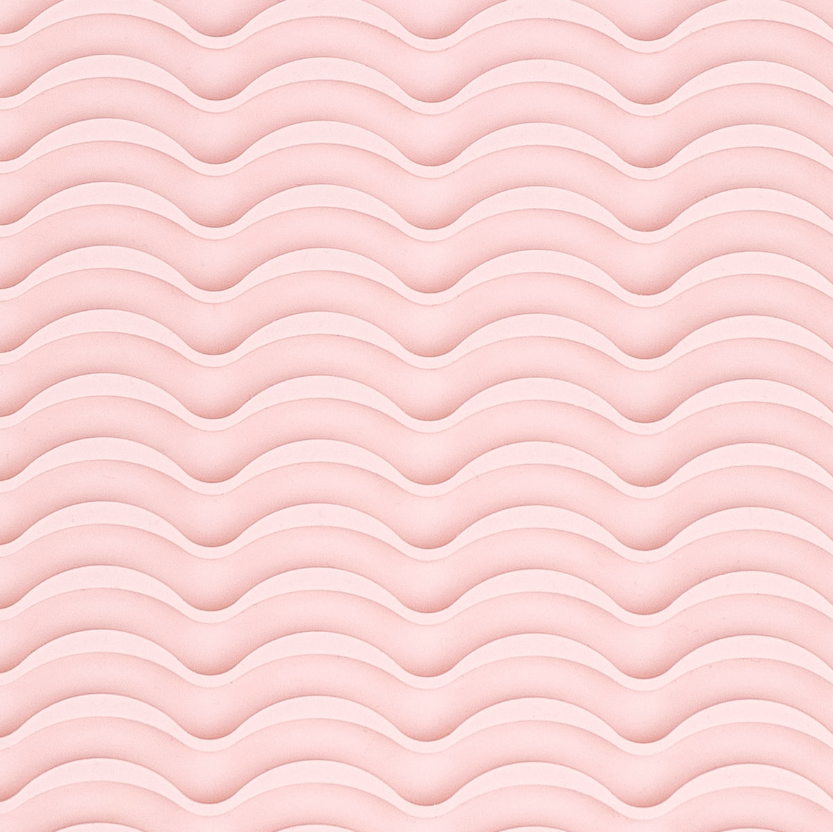 It shows a close-up of the silicone rippled surface of the styling tool heat-resistant mat.