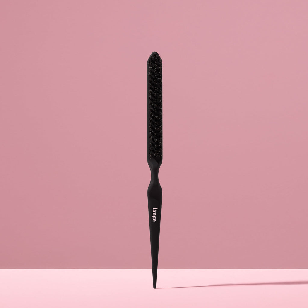 black L’ange teasing brush standing upright on pink background