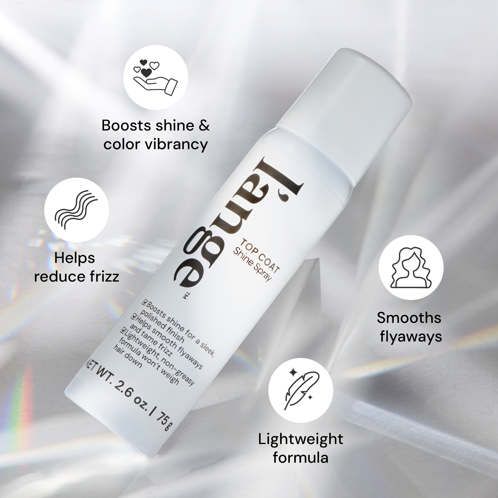 L'ange Top Coat Shine Spray bottle on a reflective surface with icon callouts reading "Boosts shine & Color Vibrancy " "Helps reduce frizz" "Smooths flyaways" and "lightweight formula"