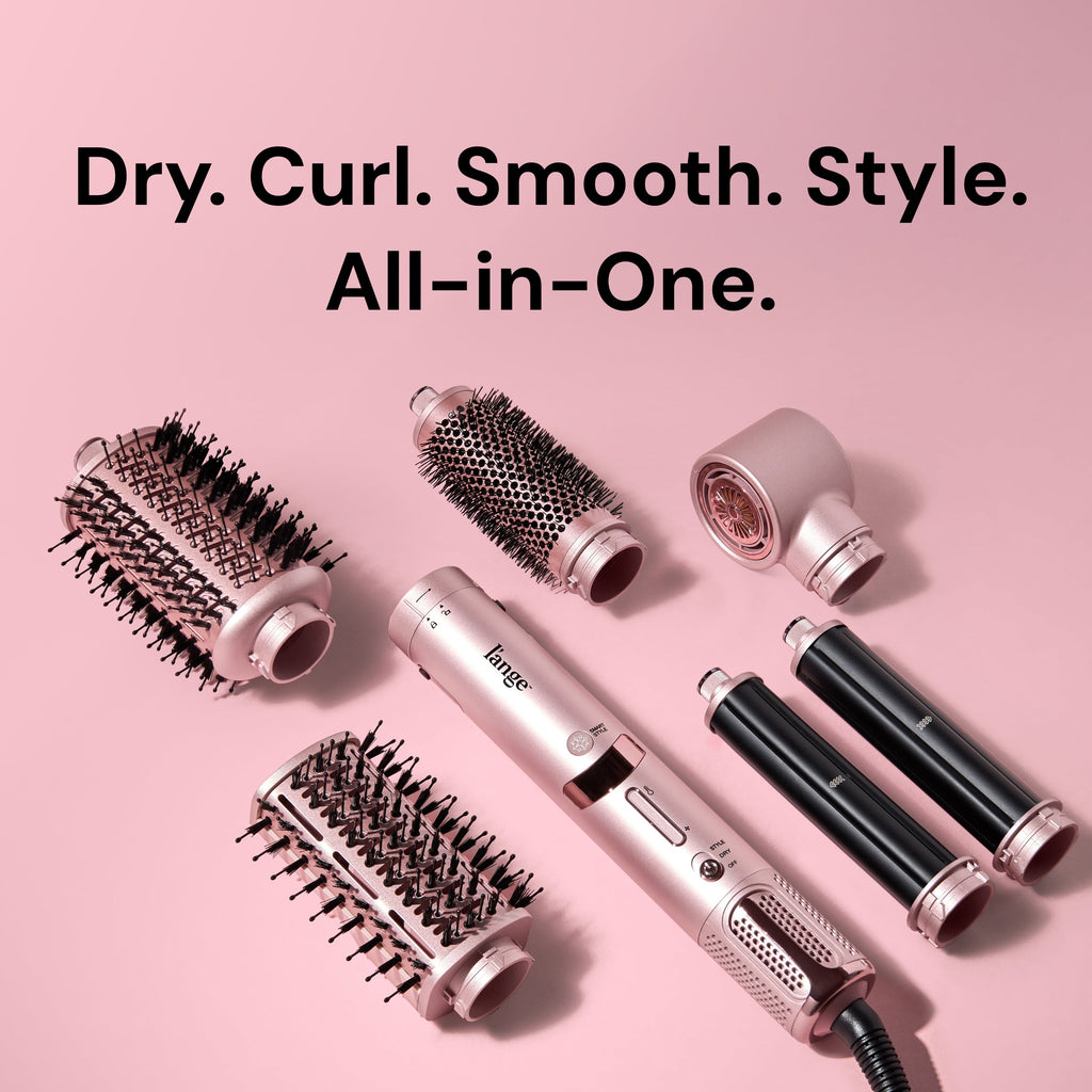 Flat lay of TurboStyle base and attachments on pink background. Text reads "Dry. Curl. Smooth. Style. All in One."