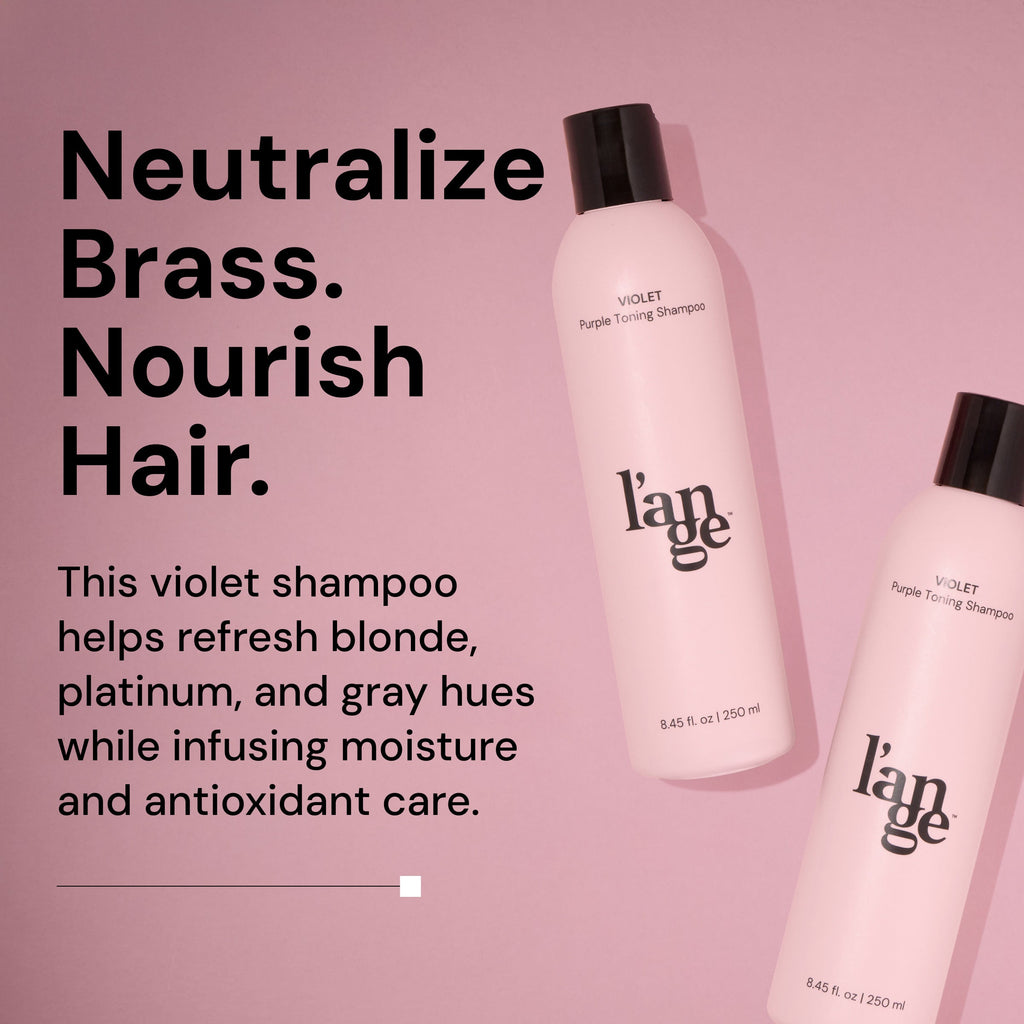 Two bottles of L’ange Violet Purple Toning Shampoo on a pink background. Bold black text reads: ‘Neutralize Brass. Nourish Hair.’ Subheading says: ‘This violet shampoo helps refresh blonde, platinum, and gray hues while infusing moisture and antioxidant care.