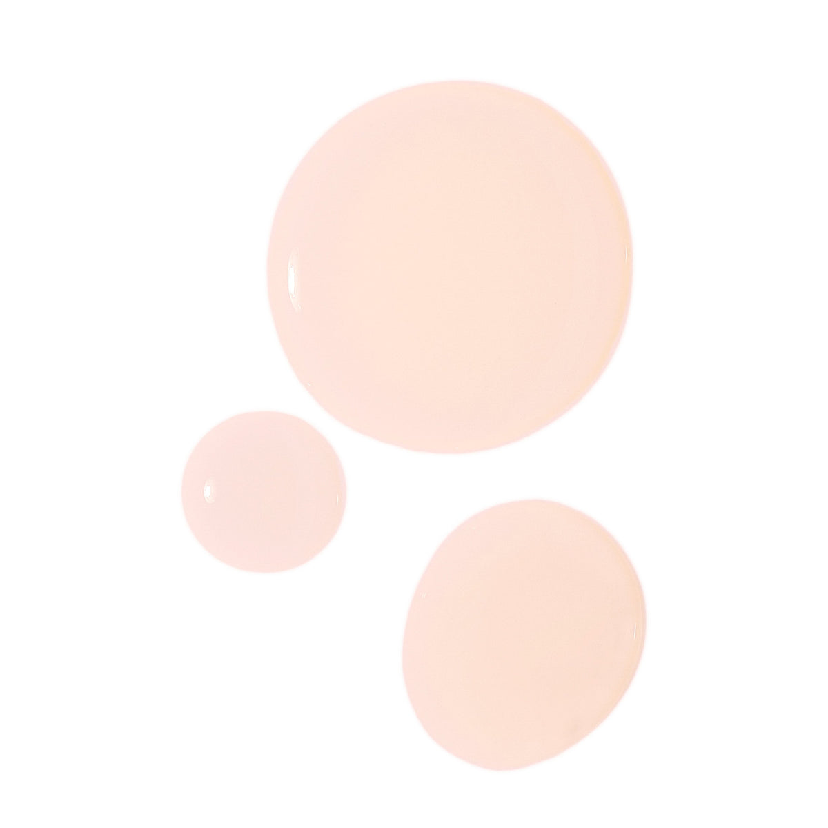 Three different sizes of The Oil Serum Hybrid Styler showcasing a light peach tone and silky texture.